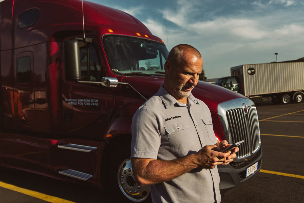 AI-generated photo: an owner-operator standing in front of his own truck
