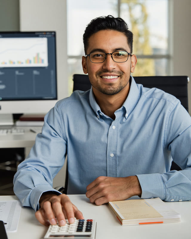 AI-generated portrait: accountant at his desk with a calculator and invoices